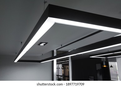 LED white cold light over workplaces. Modern office lighting.