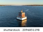 Ledge Light lighthouse in Connecticut as viewed from the ocean side. Twin cities of Groton on the right and New London on left, can be seen in the background.