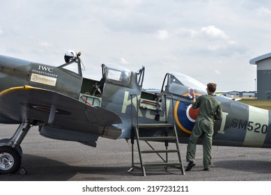 Lee On The Solent, England, September 1st 2022. SM250 Twin Seat Spitfire Parked On The Runway Of Solent Airport Between Flights. A Crew Member Cleans The Glass.