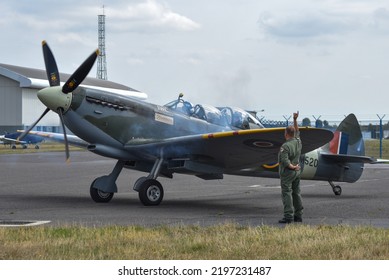 Lee On The Solent, England, September 1st 2022. SM250 Twin Seat Spitfire Taxiing On The Runway Of Solent Airport While A Crew Member Gives Hand Signals To The Pilot. 