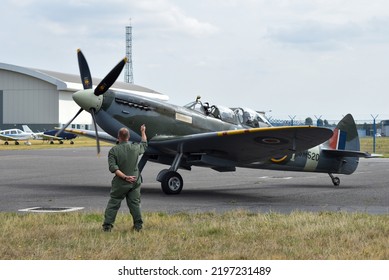 Lee On The Solent, England, September 1st 2022. SM250 Twin Seat Spitfire Taxiing On The Runway Of Solent Airport While A Crew Member Gives Hand Signals To The Pilot. 