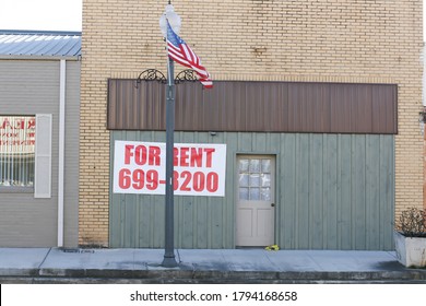 Leeds, AL / USA - April 14, 2019: For Rent Sign In Small Town America With An American Flag Out Front.