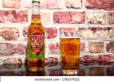 Leeds England UK July 15 2020 Bottle and glass of desperados tequila flavoured lager on a glass table top - Editorial