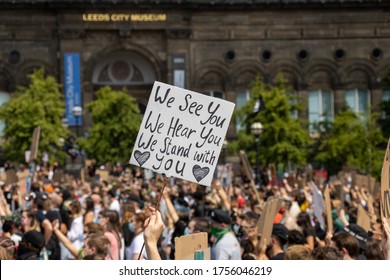 Leeds UK, 14th June 2020: Black lives matter protesters in the Leeds City Centre protesting about Black lives with a white woman holding a sign that says We See You, We Hear You,  We Stand with you