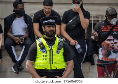 Leeds UK, 14th June 2020: Black Lives Matter Protesters In The Leeds City Centre Protesting About Black Lives Showing A Black West Yorkshire Police Officer Watching Over The Protesters.