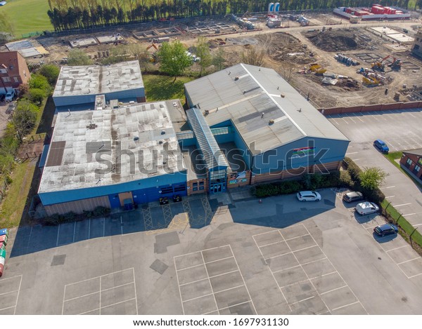 Leeds UK,\
23rd April 2019: Aerial photo of the Garforth Sports Leisure Centre\
in the town of Leeds West Yorkshire UK, showing a top down view of\
the building and car park parking\
lot.