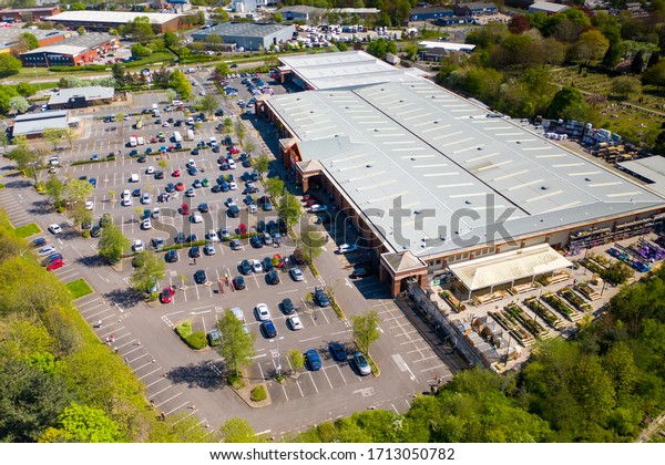 Leeds, UK, 24th April 2020: Aerial photo of the B&Q\
hardware store in Beeston on a busy day with people queuing 2\
metres apart due to social distancing, covid-19 coronavirus, and\
the UK lockdown 