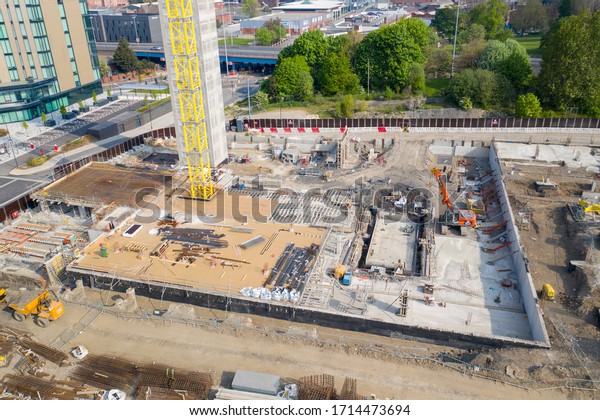Leeds UK,\
26th April 2020: Aerial photo of construction work being done in\
the Leeds town centre at the Quarry Hill car park showing the\
building site with diggers and yellow\
crane