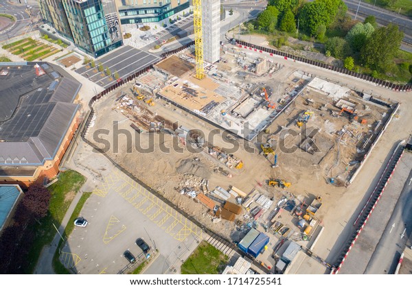 Leeds UK, 26th April 2020: Aerial photo of\
construction work being done in the Leeds town centre at the Quarry\
Hill car park showing the building site and yellow crane and\
diggers on the site