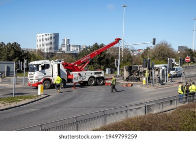 Leeds UK, 5th April 2020:  A Major Accident In The Leeds City Centre Involving A Large Refuse Garbage Truck That Has Crashed And Ended Up On Its Side, Showing A Recovery Truck Preparing To Recover It