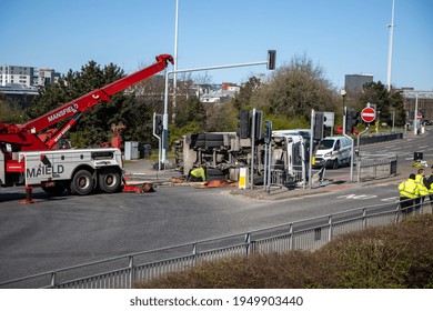 Leeds UK, 5th April 2020:  A Major Accident In The Leeds City Centre Involving A Large Refuse Garbage Truck That Has Crashed And Ended Up On Its Side, Showing A Recovery Truck Preparing To Recover It