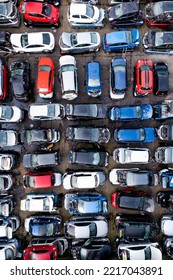 LEEDS, UK - OCTOBER 3, 2022.  Aerial View Directly Above Rows Of Scrap Metal Cars Involved In Traffic Accidents In A Car Insurance Concept Background With Copy Space