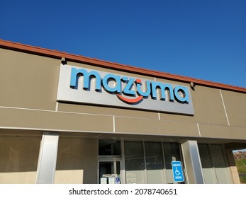 Lee's Summit Missouri USA - November 18 2021: Sign For Mazuma Credit Union On Building Exterior Beneath Blue Sky