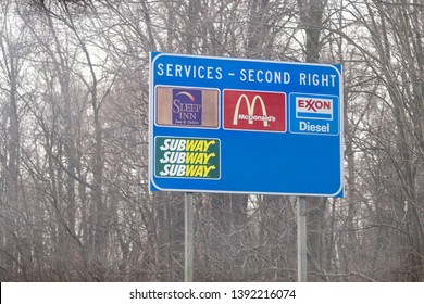 Leesburg, USA - April 6, 2018: Rural Virginia Countryside In Spring With Blue Exit Sign On Highway For Food And Service Such As Mcdonalds Fast Food, Sleep In Hotel And Exxon