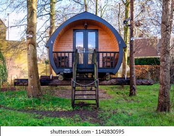 Leeuwarden, Netherlands, December 2017. Tiny house or hotelpod made from wood in the form of a covered wagon or camper on logs