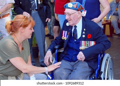 LEEUWARDEN, NETHERLANDS - May 5, 2018. Elderly Canadian War Veteran From World War Two In Wheelchair Is Telling Stories To Dutch Woman During His Visit To Holland On Liberation Day (Bevrijdingsdag). 