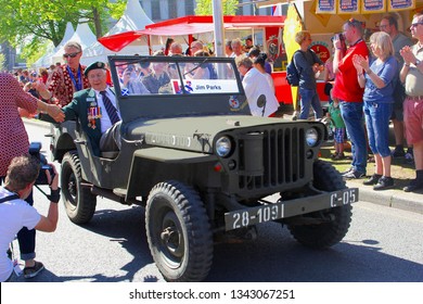 LEEUWARDEN, NETHERLANDS - May 5, 2018. Elderly Canadian War Veteran Jim Parks Drives In Oldtimer Military Jeep While Audience Is Applauding On Bevrijdingsdag (Liberation Day). End Of War Celebrations.