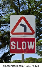 Left bend ahead and slow down sign
