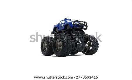 Left bottom side view of a blue monster truck toy with large black tires on white