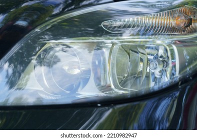 The Left Front Headlight Of A Car Close-up.