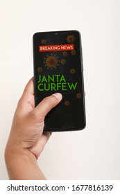 Left Hand Holding Mobile With Screen Janta Curfew Poster