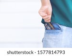 Left hand pulling or keeping black color credit card (mock up) from or into rear jeans pocket
