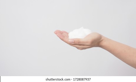 Left Hand Washing Gesture With Foaming Hand Soap On White Background.