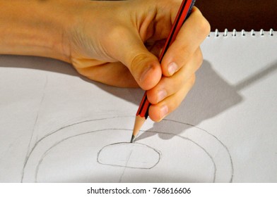 Left Handed Artist With An Awkward Pencil Grip Sketching Symmetrical Geometric Ovoid Shapes