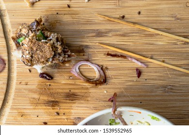 Left Over Bitten Turkey Sandwich With Food Crumbs On Wooden Platter