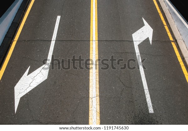 left / right,\
direction arrows on asphalt road\
-