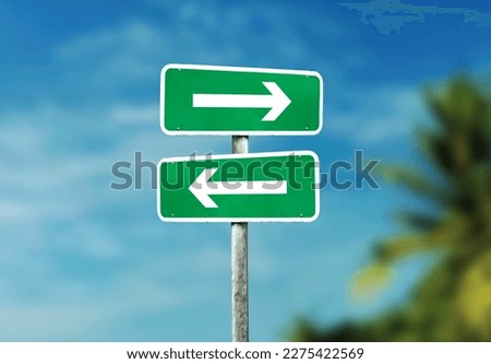 left and right direction sign on road, blue sky background