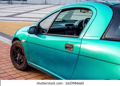 left side of small emerald coupe sportcar