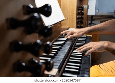 Left side view of Organist's hands playing organ in Catholic Church. - Powered by Shutterstock