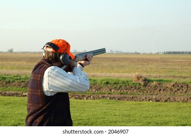 A Left-handed Shotgun Shooter On The Trap Range Closeup