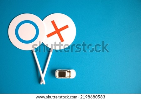 Left-leaning photo of Marubatsu flip and car with blue background