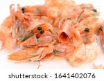 leftover boiled shrimp on a white background. waste food shrimp peeled, detail of the heads and eyes of this seafood