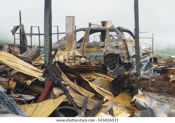 leftover of burnt out property automobile workshop\
after fire.