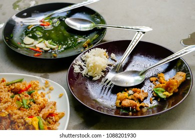 The Leftover Food And Dirty Dishes On The Restaurant Table.