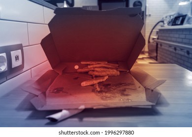 Leftover Pieces Of Pizza Crust Laying In The Pizza Box Carton. Leftovers Pizza In A Cafe