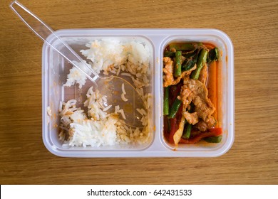 Leftover Thai Food Rice With Stir Fried Pork Belly And Red Curry Paste With Stringbean In A Plastic Box, On Top View.