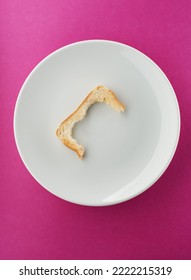 Leftover Toast Crust On White Plate And Bright Pink Background