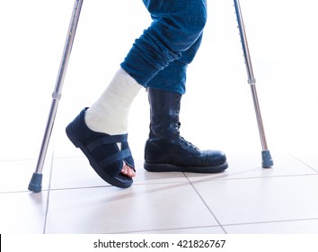 Leg cast and combat boot (war and injury) - one foot in a cast and one in a combat boot - concept image (isolated on white)