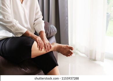 Leg Cramp, Senior Woman Suffering From Leg Cramp Pain At Home, Health Problem Concept