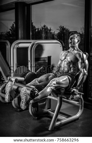 Leg Exercises - Man Doing Leg With Machine In Gym