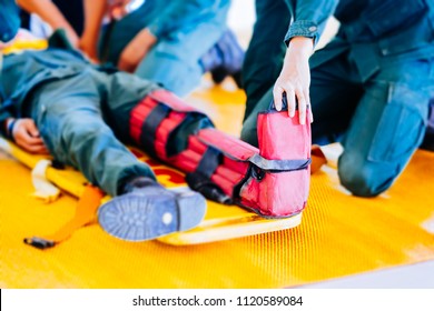 Leg Fracture To Splinters On Portable Stretcher. Injury Or Illness  Leg Of Soldier In Stretcher For Transfer To Hospital And Treatment By Doctor To Safety. First Treatment On Patient For Rescue Safety