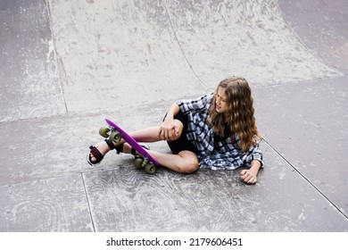 Leg And Knee Injury On Penny Board. Child Traumatology. Child Girl Falling From Skate Board And Get Injured And Feeling Pain