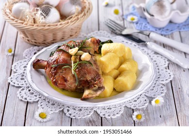 Leg of lamb with spinach and potato dumplings in spring with daisy flowers in the background