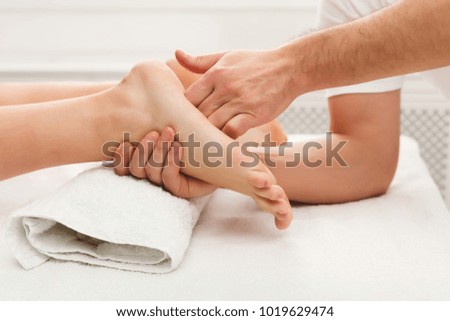 Leg massage. Physiotherapist pressing specific spots on female foot. Professional health and wellness acupressure manipulations, copy space, closeup