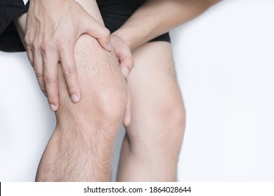 Leg muscle pain.young man  and grasped his muscles. With foot pain and stretching, fatigue muscles to alleviate pain, health concepts. - Shutterstock ID 1864028644