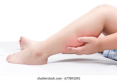 Leg Pain Or Calf Muscle In A Boy On Bed Isolated On White Background, Healthy Concept